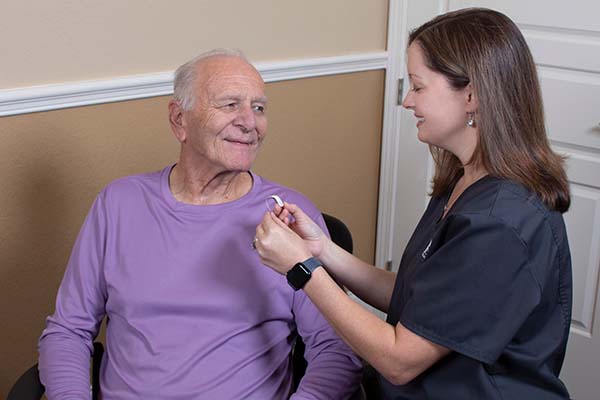 Provider talking with a patient about hearing aids.